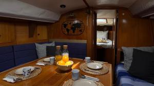 a wooden table with a bowl of oranges on it at Velero Puma 32 in Caleta de Sebo