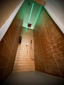 a bathroom with a shower with a phone on the wall at Kore Suite Napoli in Naples