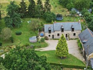 an aerial view of a stone house with a yard at Longère en Bretagne in Nouvoitou