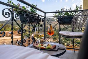 a table with a plate of food and a glass of wine at Tosco Suite "Solis" in Sasso dʼOmbrone