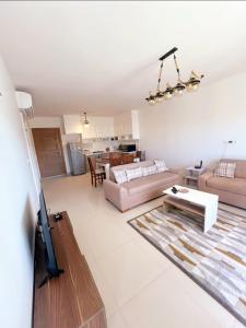 a living room with a couch and a table at شاليه فى مراسى الساحل الشمالى مارينا 2 in El Alamein