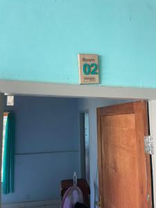 a room sign on a shelf above a door at Senaru Garden Homestay in Senaru