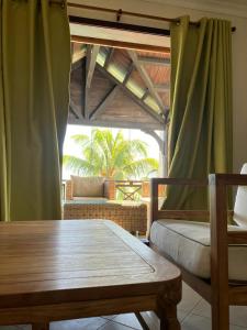 a room with a table and a chair and a window at Sunset Boulevard, Grand Baie in Grand Baie