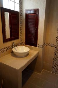 a bathroom with a sink and a mirror at Hathai House in Lamai