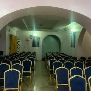 a room with rows of chairs and an archway at HP Pavilion in Abuja