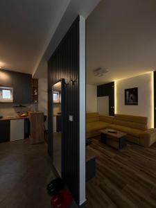a living room with a couch and a kitchen at APARTMANI LAVAZZA in Vlasotince