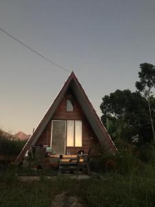 a small house with a bench in front of it at Rinjani Eger Bungalow in Sembalun Lawang