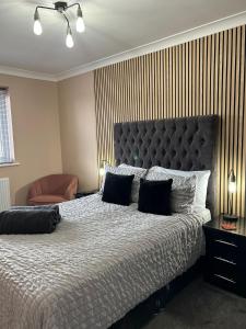 a bedroom with a large bed with black pillows at Cathedral Court in Brumby