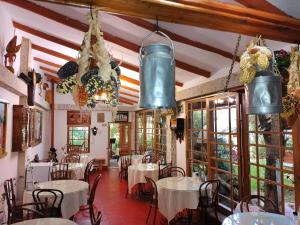 a room with tables and chairs in a restaurant at Hotel Museo Casona Ugarte Leon in Concepción