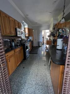 a kitchen with wooden cabinets and black counter tops at Large Suite w/ Private Bath,great location in Boston