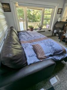 a large bed in a room with a large window at Large Suite w/ Private Bath,great location in Boston