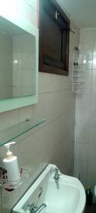 a white bathroom with a sink and a mirror at Mar del Plata in Mar del Plata