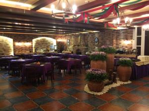 a dining room with purple tables and chairs at The Royal Pinnacle Hotel in Zhuhai