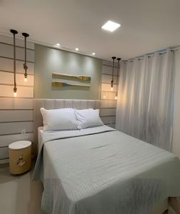 a bedroom with a large white bed in it at Flat térreo com piscina privativa in Porto De Galinhas