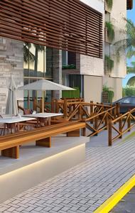 a restaurant with wooden benches and tables in front of a building at Flat térreo com piscina privativa in Porto De Galinhas +35 photos