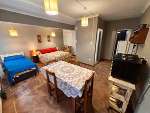 a living room with a bed and a table and a room at Opera Apart Suites in Salta