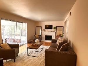 a living room with a couch and a fireplace at Great Stay in South San Jose in San Jose