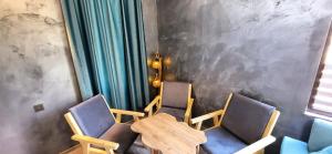 a dining room with two chairs and a table at Shahdag Mountain House in Qusar