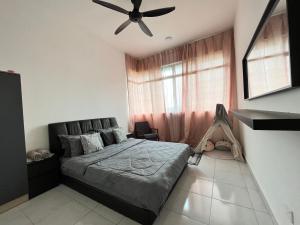 a bedroom with a bed and a ceiling fan at Condominium Seri Alam, Masai #ANhome in Masai