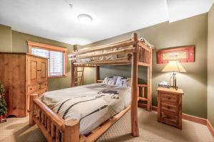 ビッグ・ホワイトにあるTreetops Ski Luxury Townhouseのベッドルーム(二段ベッド1組、ナイトスタンド付)