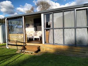a screened in porch of a tiny house at Te Puru B8 - 2 bedroom chalet in Te Puru