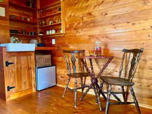 a small table and two chairs in a kitchen at Cape Foulwind Clifftop Cabin in Cape Foulwind