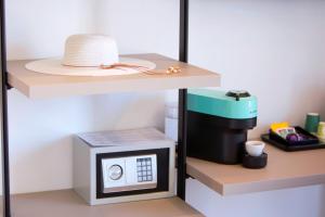 a hat sitting on a shelf next to a microwave at LuMar Luxury Sorrento in Sorrento