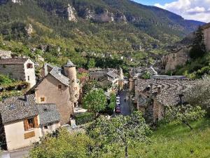 an aerial view of a village in a mountain at Hôtel BURLATIS in Sainte-Énimie