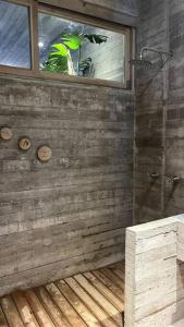a person in a bathroom with a window and a shower at Lua - Casa Macu La Saladita surf break in La Salada