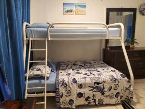 a bunk bed in a room with a bed and a stool at Coco Sol 2 by MyMiamiStay in Miami