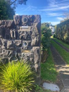 a stone wall with two speakers on it at Joe & Mary's Comfy homestay room in Auckland