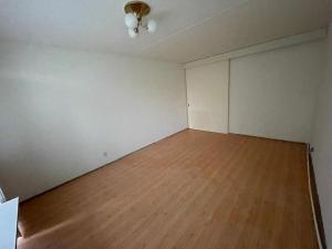 an empty room with a wooden floor and white walls at Empty 2-room apartment in green Kerava in Kerava