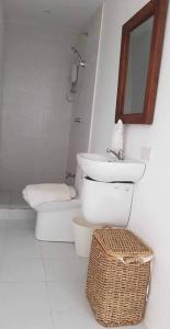 a bathroom with a sink and a toilet and a mirror at Two Bedroom Beachfront Penthouse in Boracay