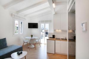 a kitchen and living room with a couch and a table at Solo Bianco Suites in Lefkada