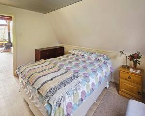 a bedroom with a bed and a table with a lamp at Cherswood Farm in Balbarrup