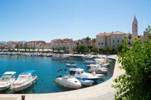a group of boats are docked in a harbor at Waterman Beach Village in Supetar