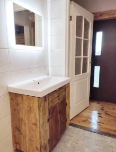 a bathroom with a white sink and a mirror at Muraka Apartement in Pärnu +5 photos