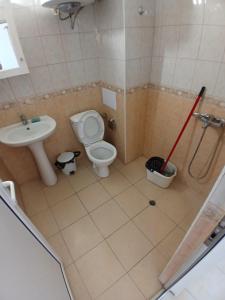 a bathroom with a toilet and a sink at Levante apartments in Nesebar