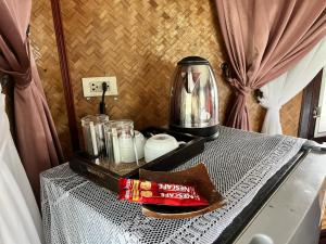 a table with a coffee maker on top of it at Kinnaree Resort Koh Kood in Ko Kood