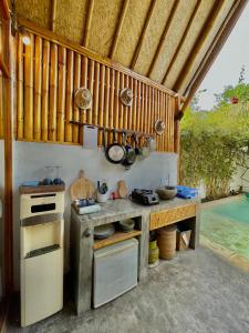 an outdoor kitchen with a stove and a sink at Sea Breeze Villas - Gili Air, Lombok in Gili Islands