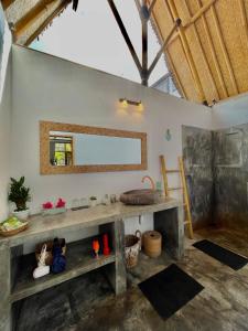 a bathroom with a sink and a mirror on the wall at Sea Breeze Villas - Gili Air, Lombok in Gili Islands