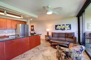 a kitchen and living room with a couch and a table at Kihei Surfside, #511 condo in Wailea