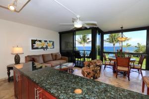 a kitchen and living room with a view of the ocean at Kihei Surfside, #511 condo in Wailea
