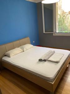 a bed with two pairs of glasses and towels on it at Kolonaki Private Rooms in Athens