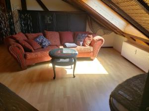 a living room with a couch and a table at Batcave in Oelsberg