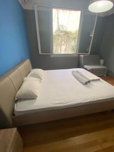a bed in a small room with a window at Kolonaki Private Rooms in Athens +13 photos