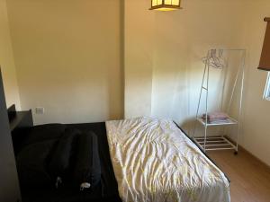 a bedroom with a bed and a lamp in the corner at 2 Bedroom 4 Pax Apartment Floor 8 Pelita Sky Garden in Nagoya +20 photos
