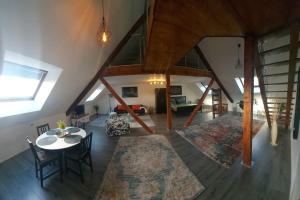 a living room with a table and chairs and a staircase at Stilvoll & Wohlfühlfaktor! in Nohfelden