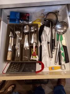 a drawer filled with utensils on a shelf at Studio Ceder 1 in Houthalen-Helchteren