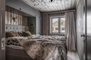 a bedroom with a large bed and a window at Lyxig stuga på Branäsberget in Sysslebäck